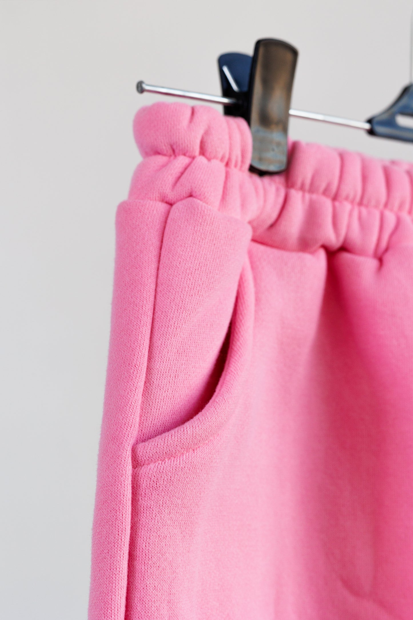 Close up of pink jogger pants on hanger