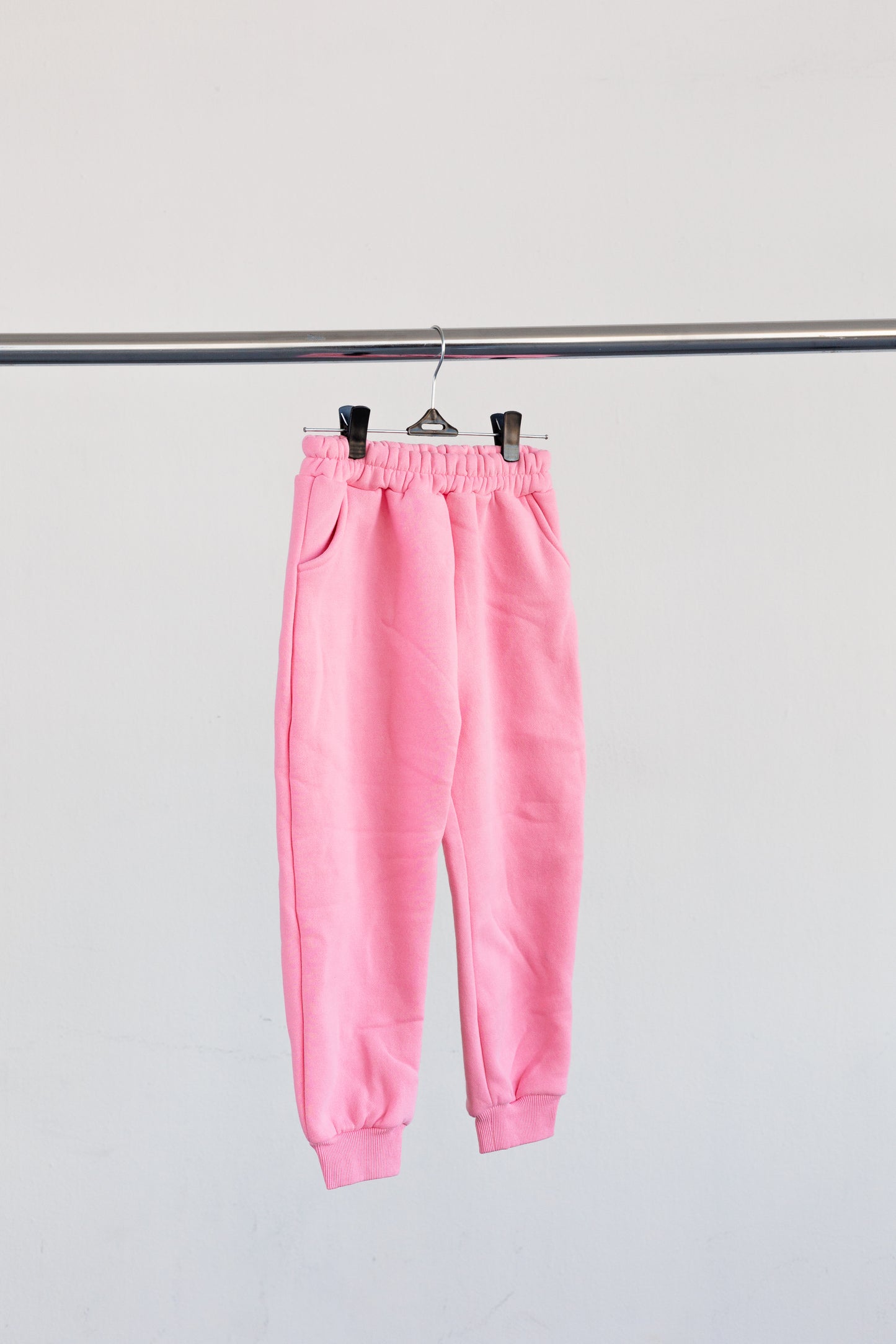 Pink jogger bottoms hanging